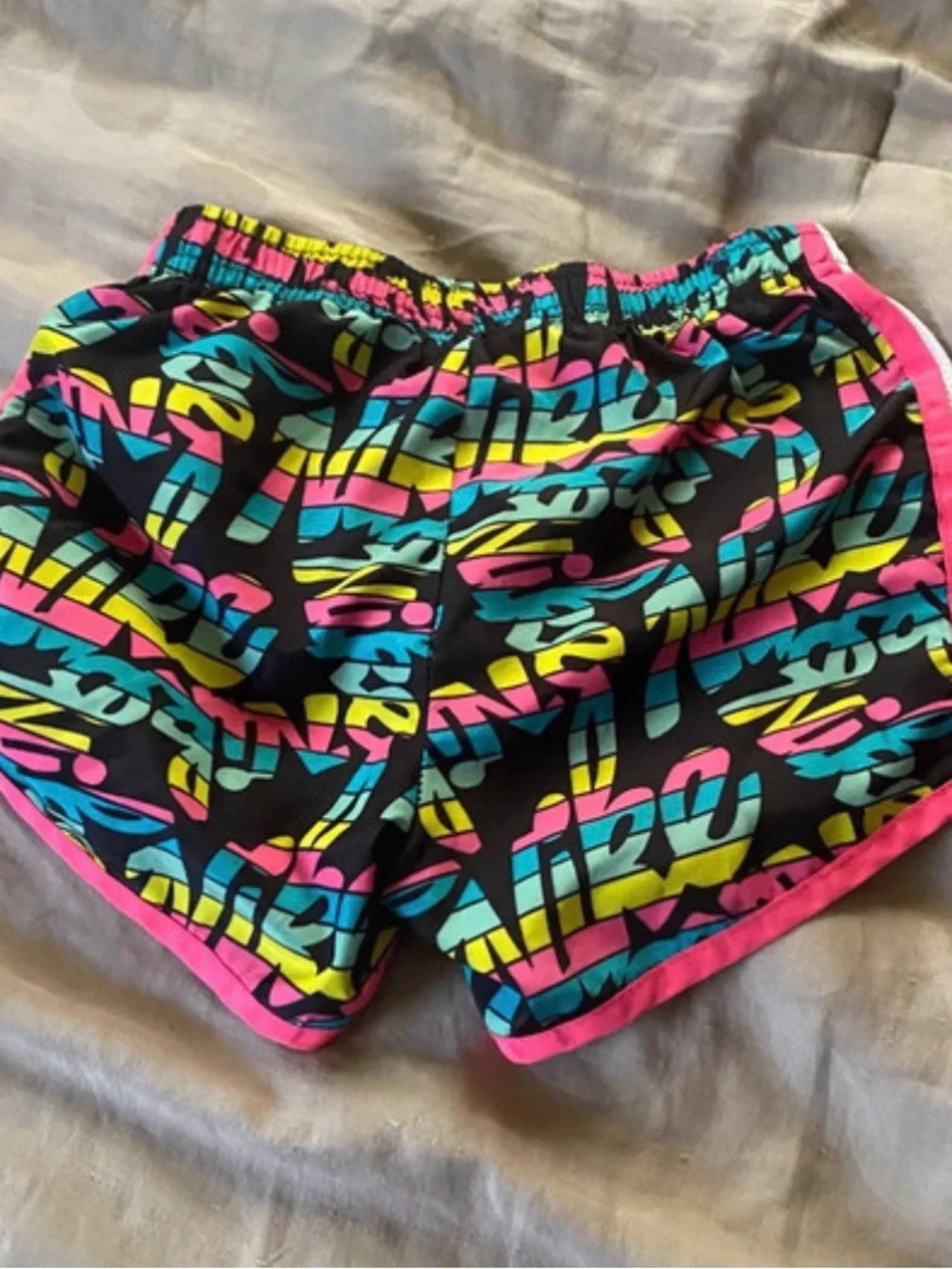 Nike Girls Black Athletic Shorts with Pink, Teal & Yellow Graphic